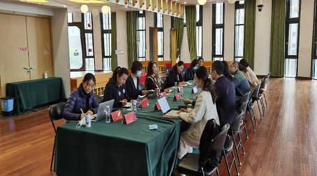 A group of people sitting around a tableDescription automatically generated with medium confidence